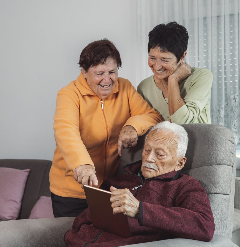 Money Carer clients looking at a tablet together