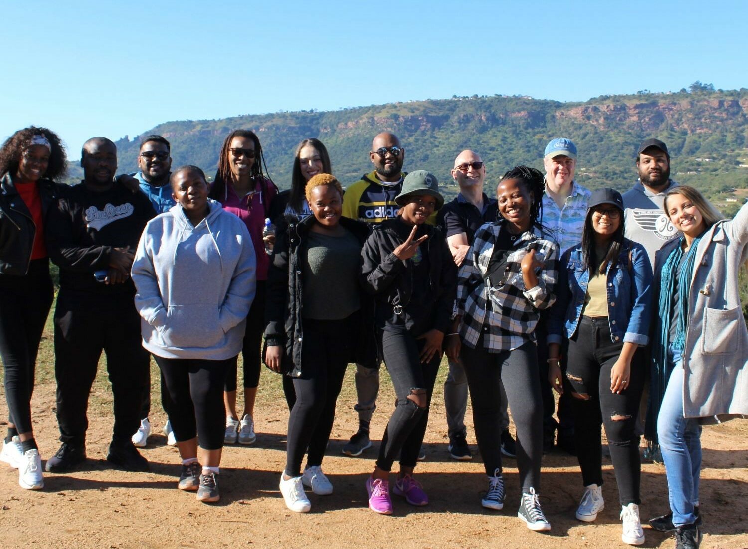 a shot of a group stood outside. this group consists of members of Money Carer, and Sprout Foundation, in South Africa.